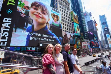 *** Shot for The Sun ***.EXCLUSIVE: Andrew Roussos, with wife Lisa, son Xander and daughter Ashley visit Times Square where a picture of their daughter, Saffie-Rose Roussos, is projected on an electronic billboard on Thursday, July 4, 2024 in New York, N.Y. Andrew Roussos' daughter Saffie-Rose Roussos, 8, was one of 22 victims killed in the Manchester bombing during an Ariana Grande concert in 2017. .Photo: James Keivom for The Sun .OK TO REUSE, OK TO SYNDICATE, NO RESTRICTIONS